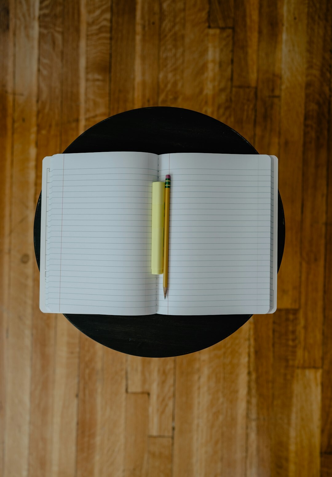 Notebook and audio recorder on a table during an interview session